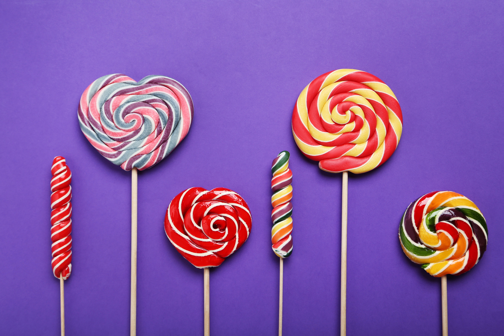 Sweet lollipop on purple background
