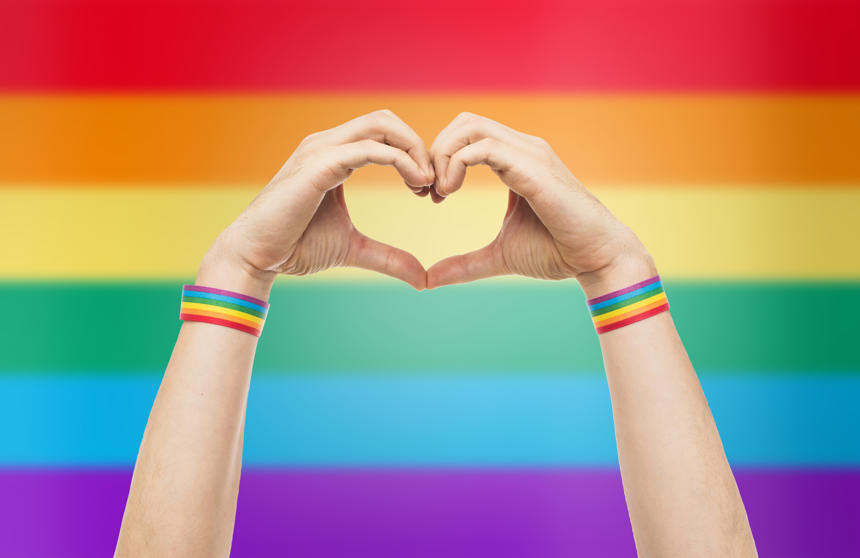 Male Hands with Gay Pride Wristbands 